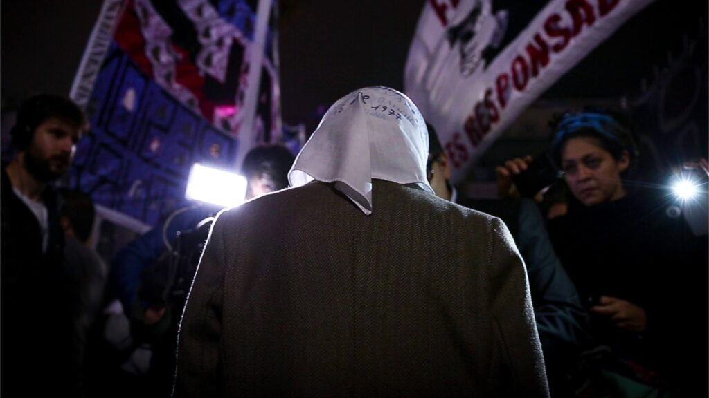 Norita Cortiñas, founder of the Mothers of Plaza de Mayo, at a nighttime rally. - The Latino Slant