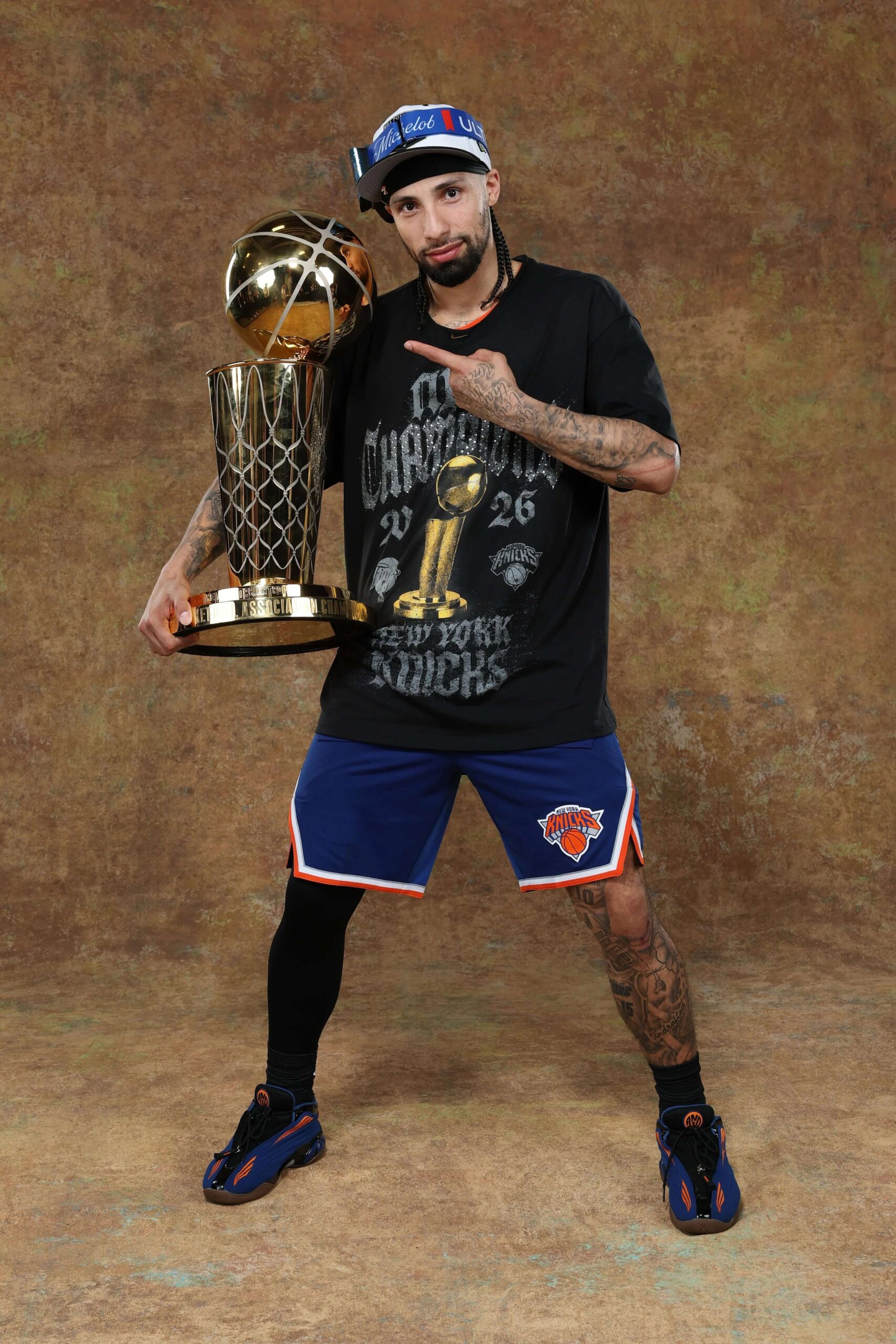 Jose Alvarado poses with the championship trophy during Knicks media day. - The Latino Slant