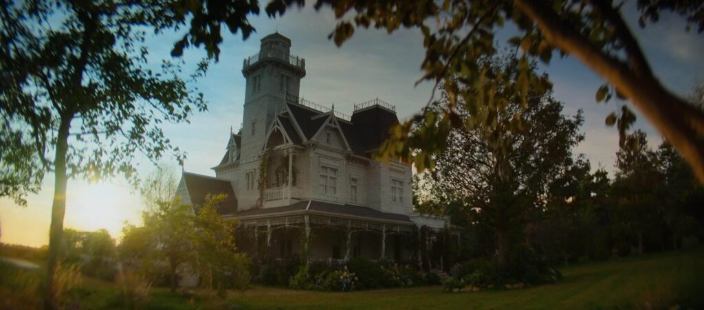 The Owens family home stands beneath a fading sky in "Practical Magic 2." - The Latino Slant