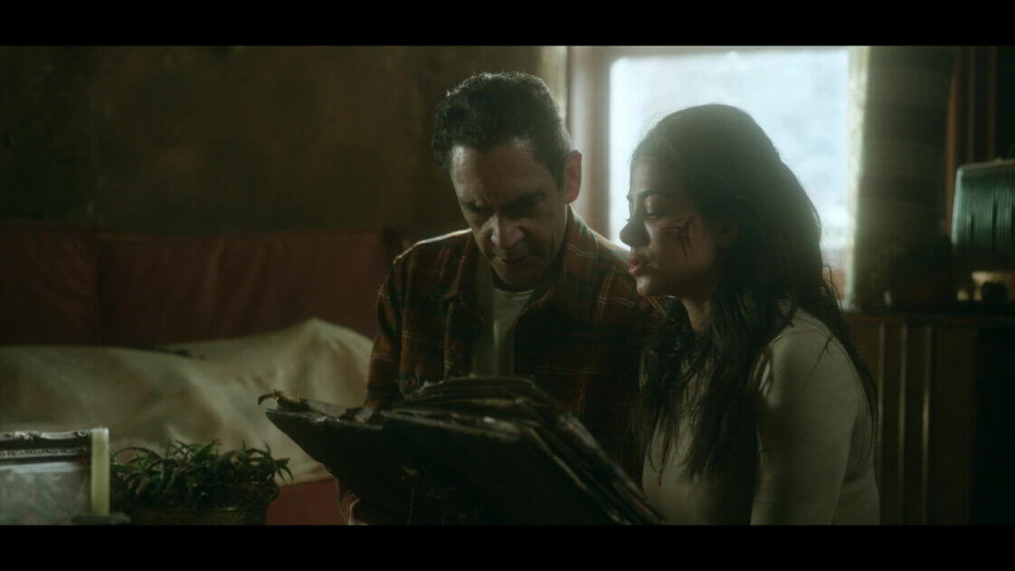 José Zúñiga and Emeraude Toubia pore over an old book in "Rosario." - The Latino Slant