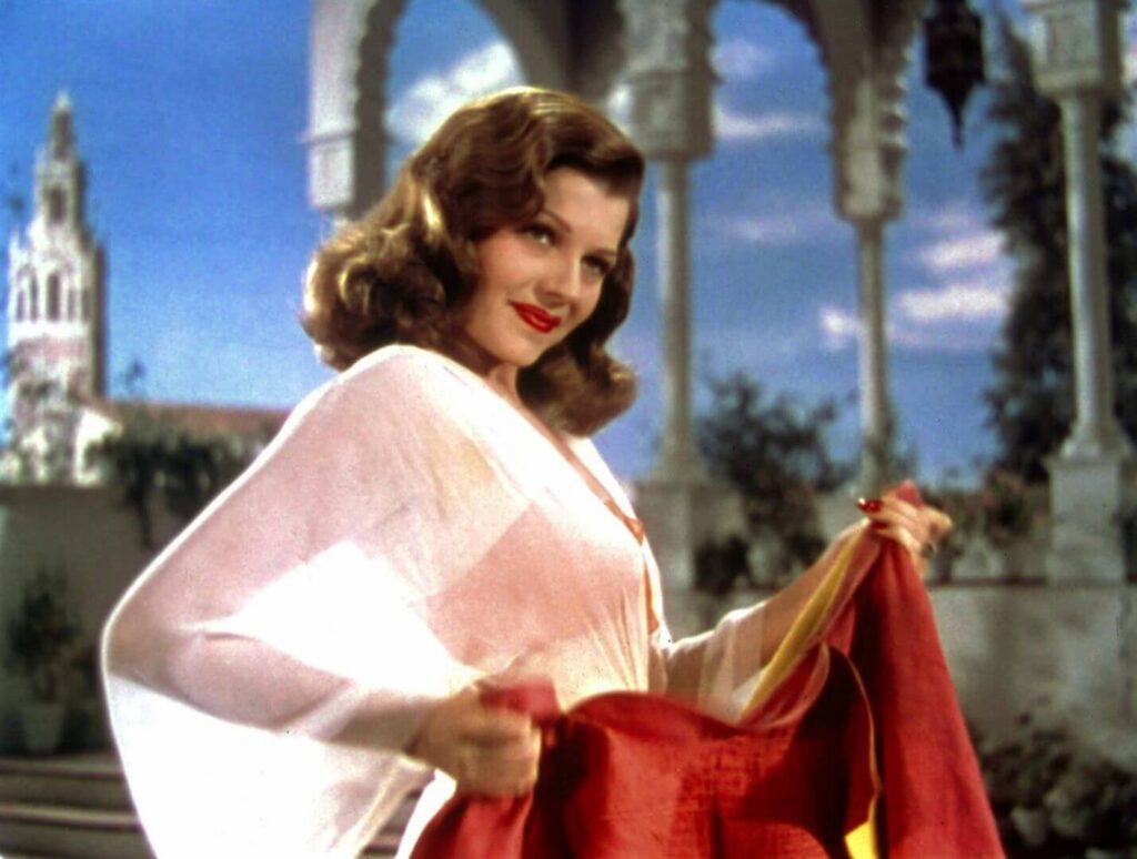 Rita Hayworth poses with a matador's cape in a scene from "Blood and Sand" (1941). - The Latino Slant