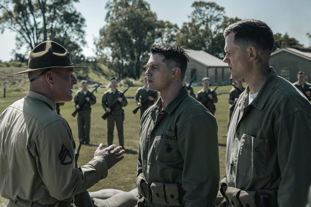 A drill instructor sizes up two new recruits during Marine Corps training in “The Mosquito Bowl.” - The Latino Slant