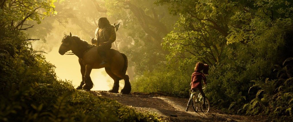 Prue comes face to face with a rider on the forest road in “Wildwood.” - The Latino Slant