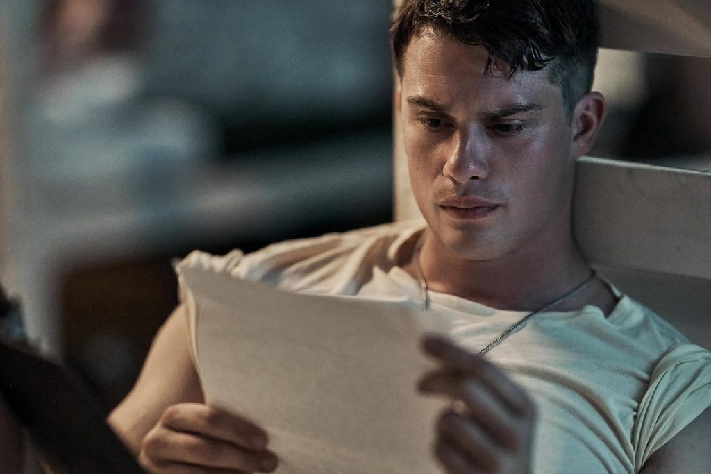 John reads a letter from home in “The Mosquito Bowl.” - The Latino Slant